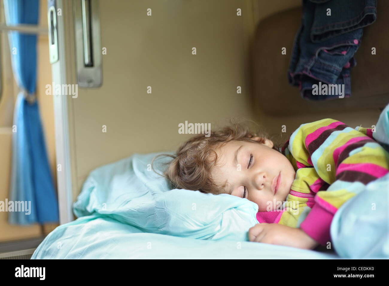 little girl sleeps in train Stock Photo