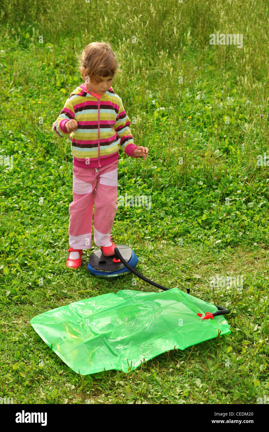 little girl pumps inflatable chair outdoor Stock Photo