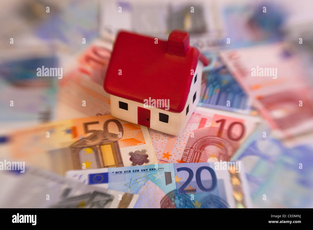 Model House on top of Euro notes currency money Stock Photo