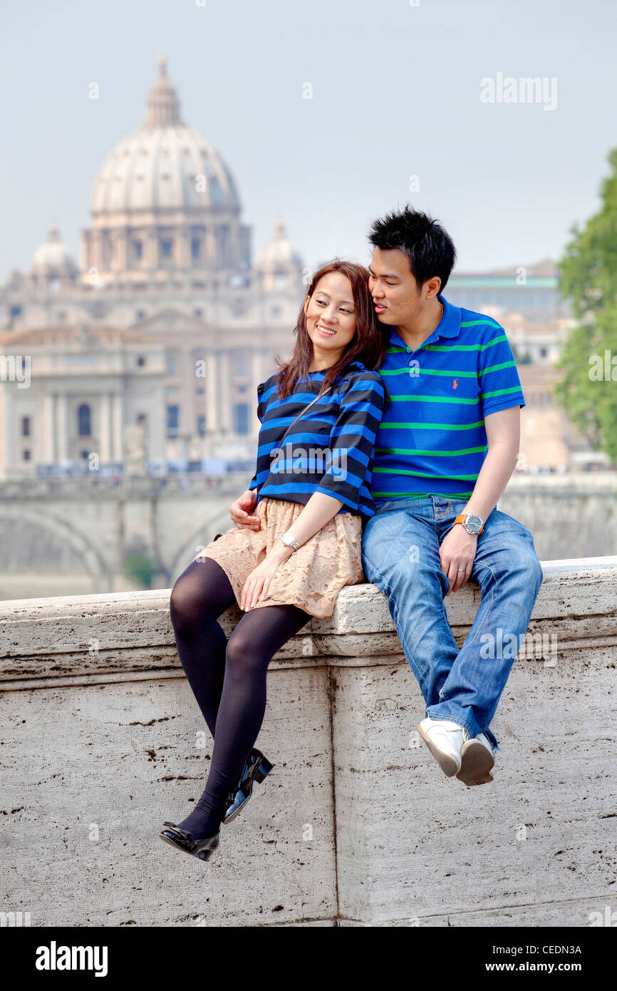 Couple sitting in front of Saint Peter's Cathedral Stock Photo
