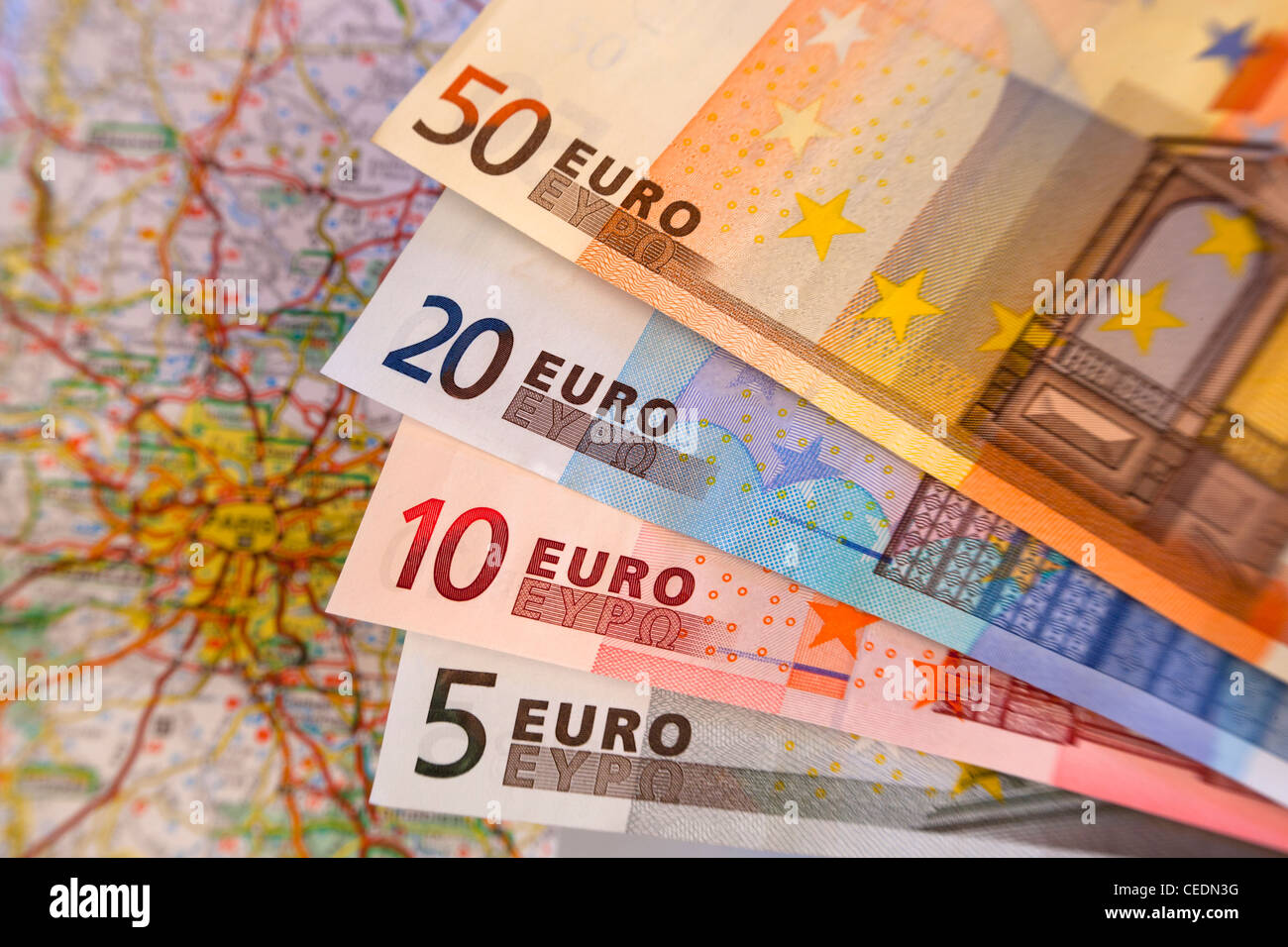 Fan of different size Euro notes currency with map in background Stock Photo
