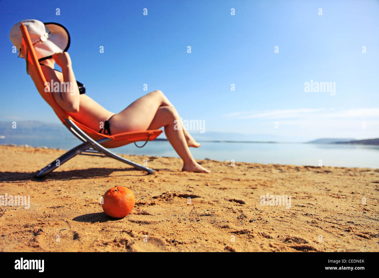 girl sunbathing on the beach with warm summer day Stock Photo