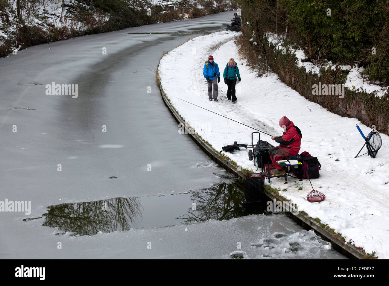 Fishermen fishing in the Coventry canal, Nuneaton, Warwickshire, after breaking the ice on the