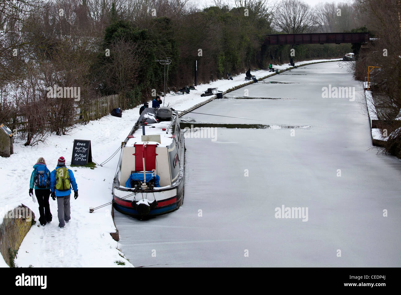 Fishermen fishing in the Coventry canal, Nuneaton, Warwickshire, after breaking the ice on the frozen canal. Stock Photo