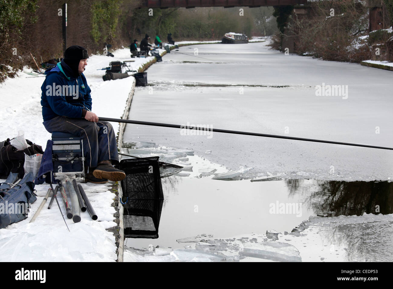 Fishermen fishing in the Coventry canal, Nuneaton, Warwickshire, after