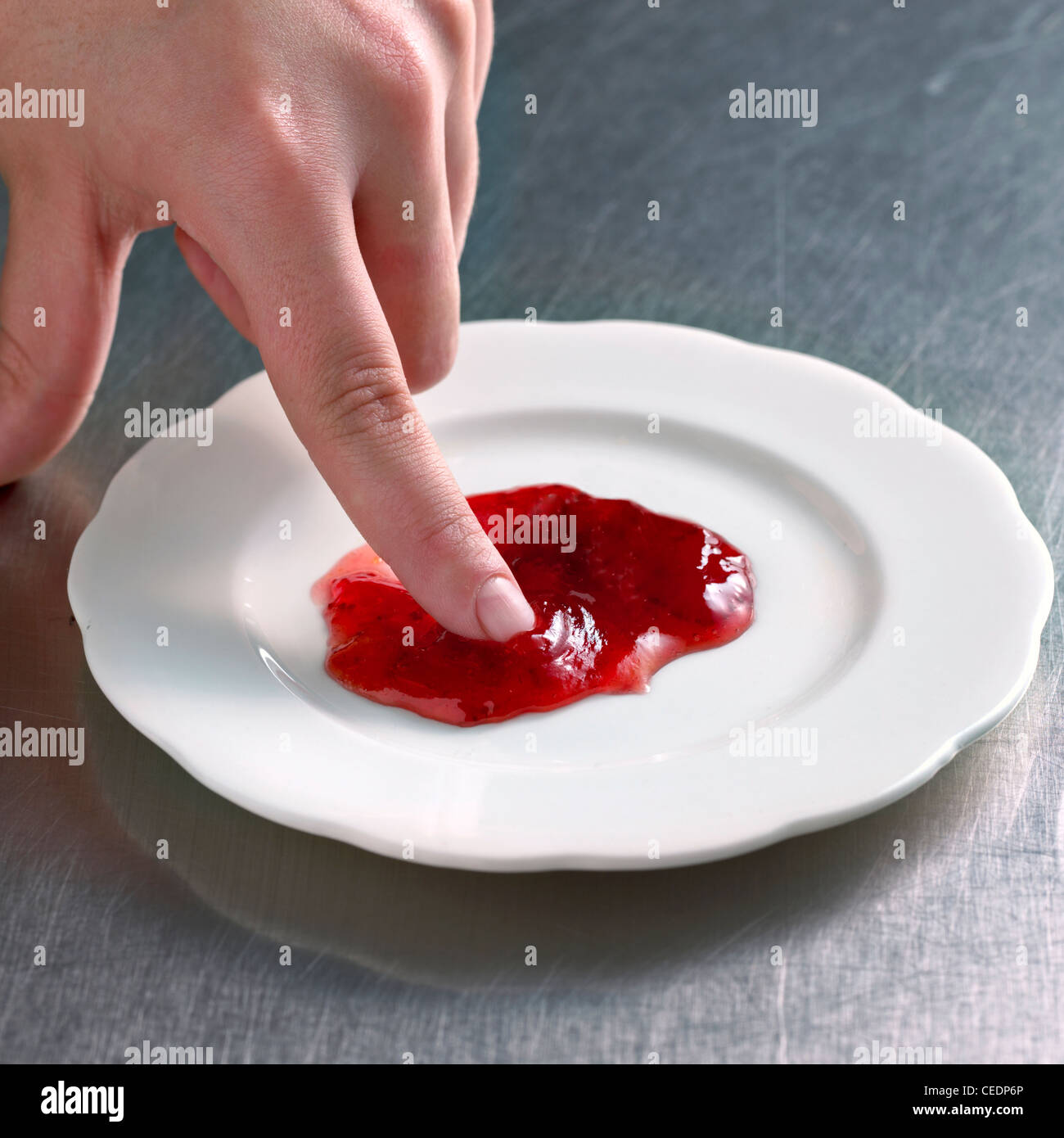 Hand doing wrinkle test of jam hires stock photography and images Alamy