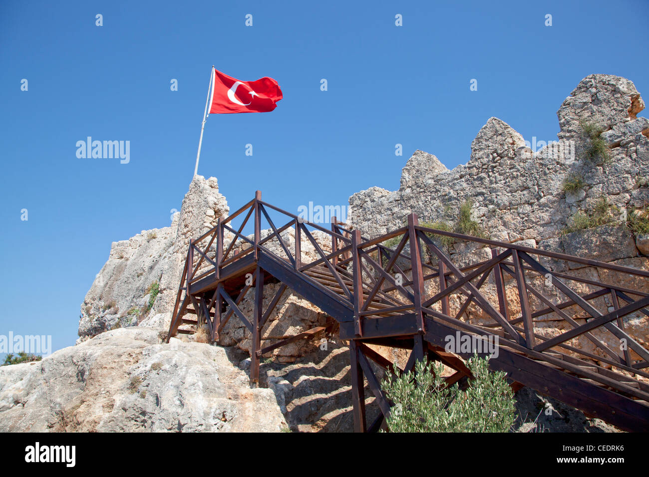 Turkey, Kalekoy, steps leading up to old fort, Turkish flag flying Stock Photo