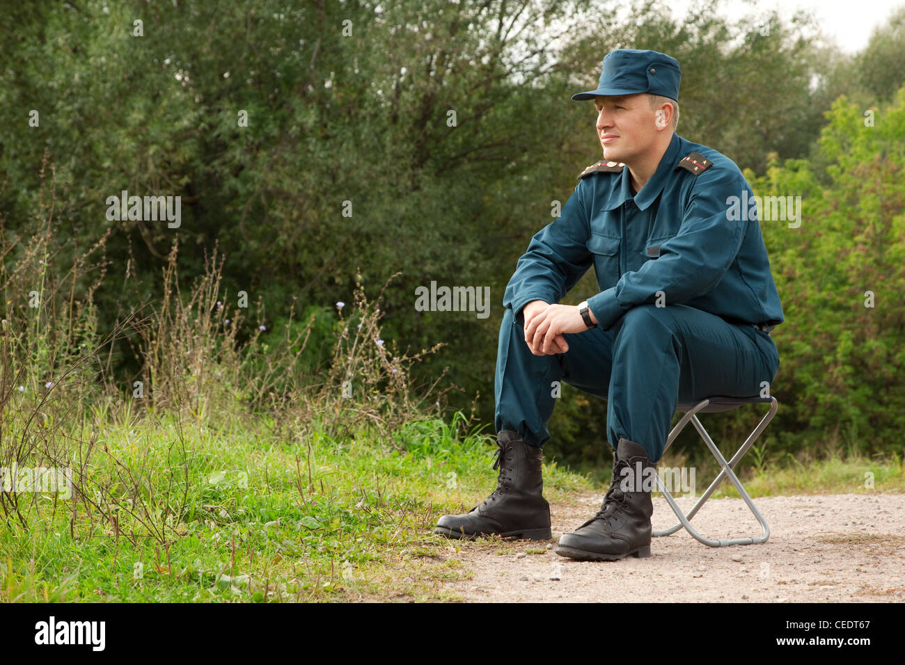 Military Man Sitting On The Camp-Chair Outdoors Stock Photo - Alamy