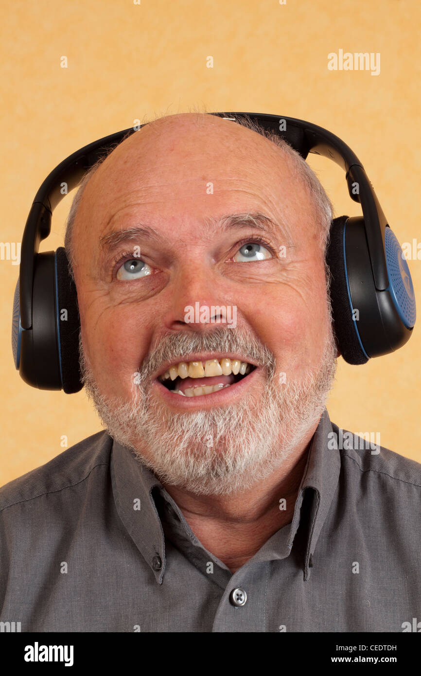 Elderly man with headphones, happy Stock Photo - Alamy