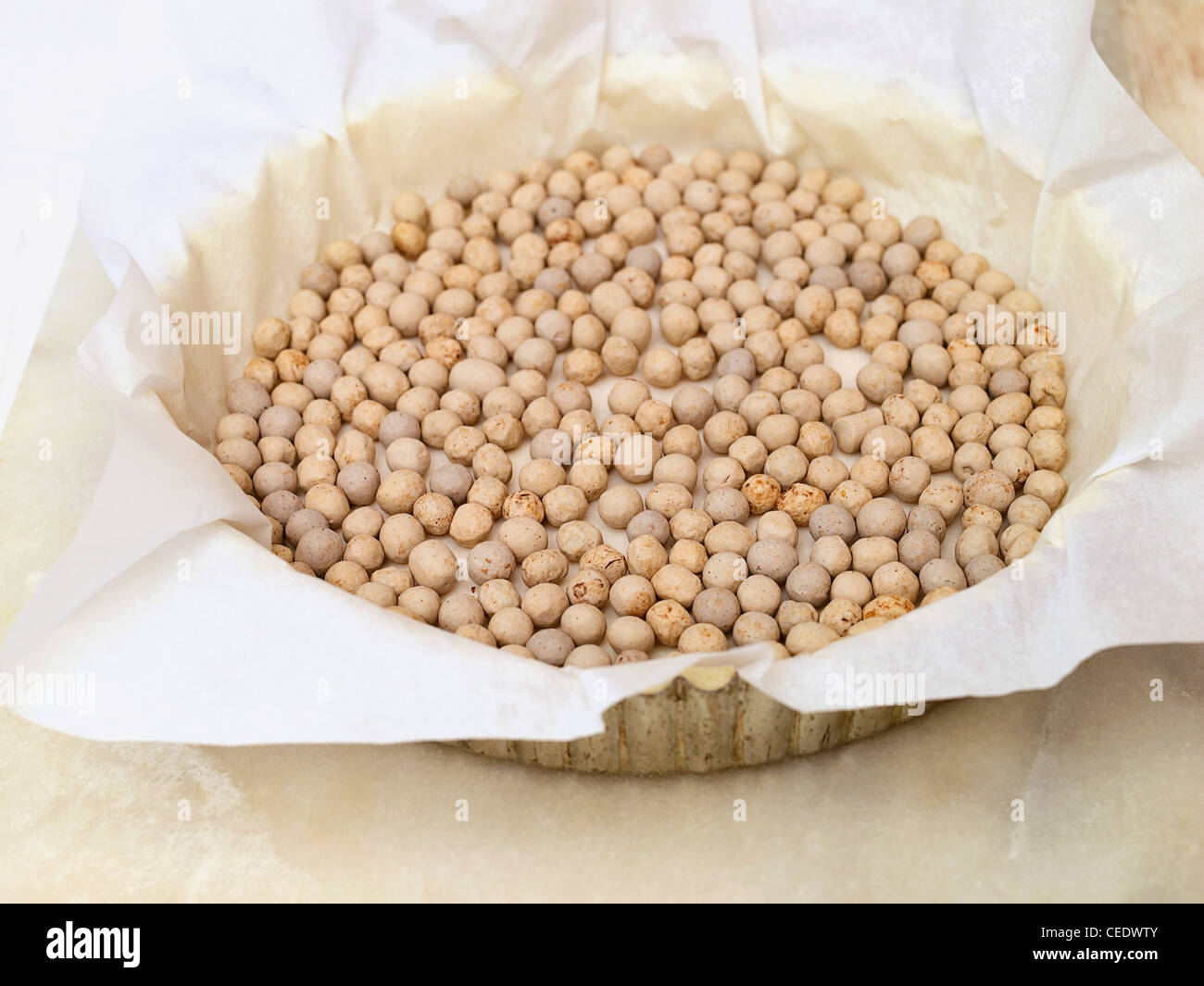 Ceramic baking beans in tart tin Stock Photo Alamy