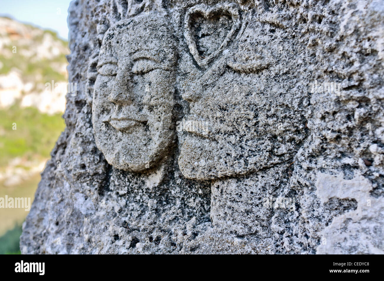 carving on the entrance to a coastal cave on the spanish island of minorca Stock Photo