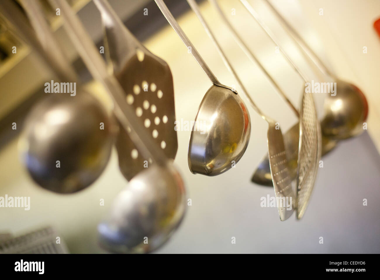 various stainless steel ladles hang in a kitchen Stock Photo Alamy