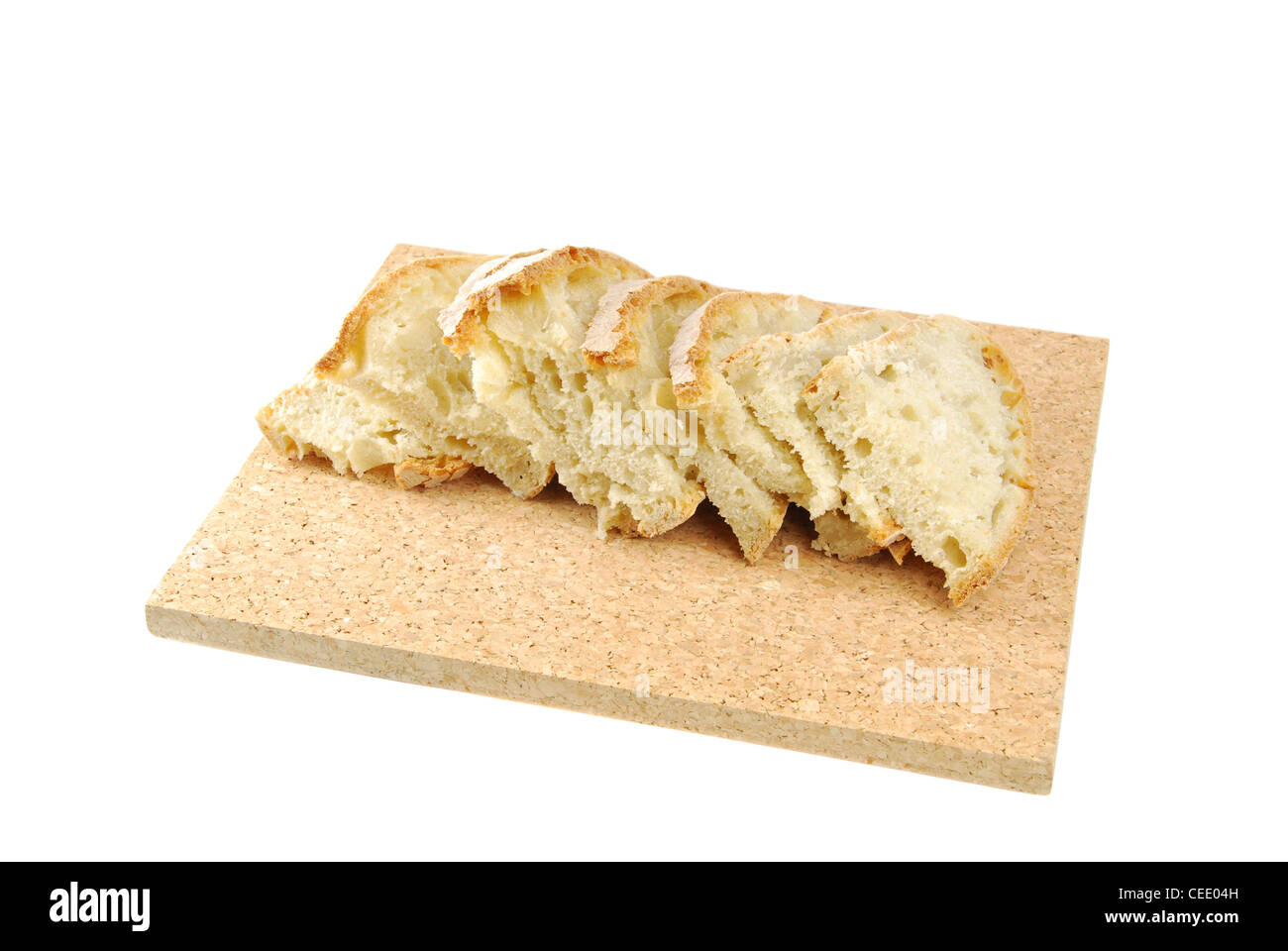 slices of cantle wheaten bread on a cork tray (isolated on white background) Stock Photo