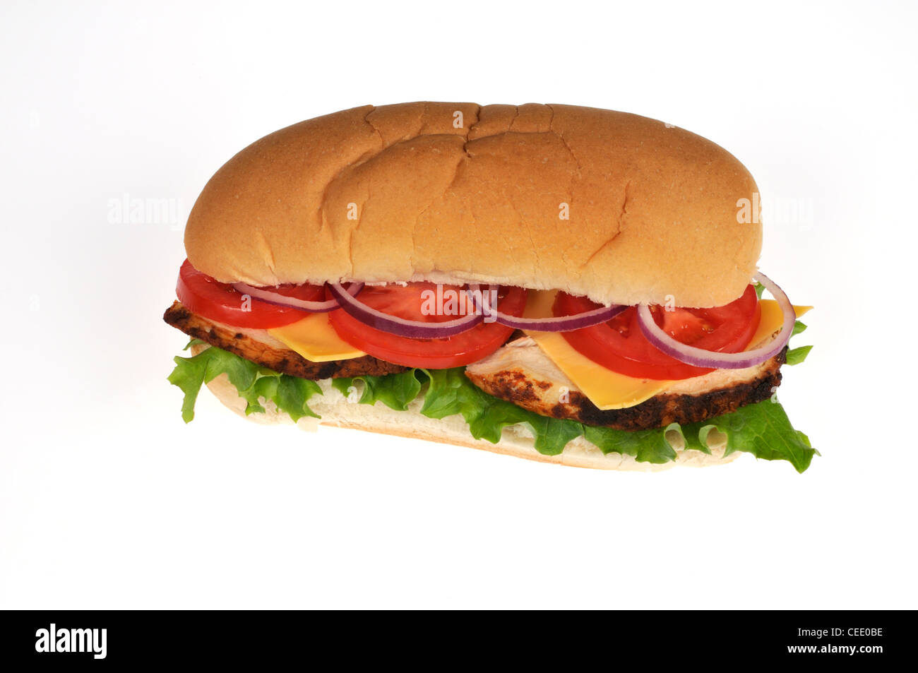 Sliced rotisserie chicken sub sandwich with cheese lettuce, tomato, red onion salad in bread roll on white background cutout. Stock Photo