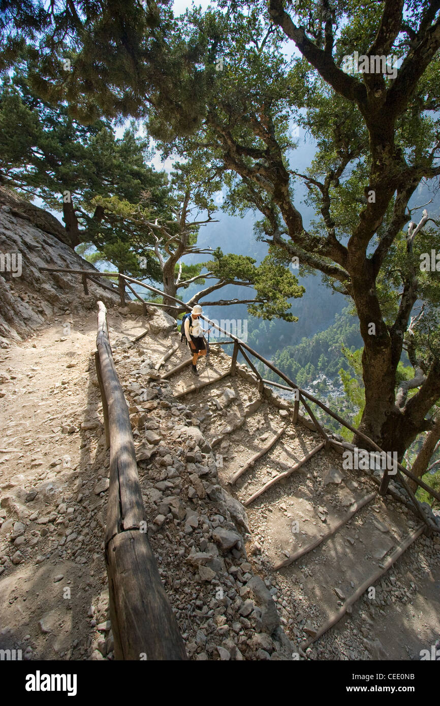 Young woman descending the steep Xyloscali footpath into the Samaria Gorge in South Western Crete Stock Photo