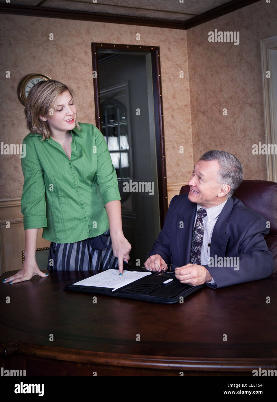 Office discussion between manager and admin Stock Photo