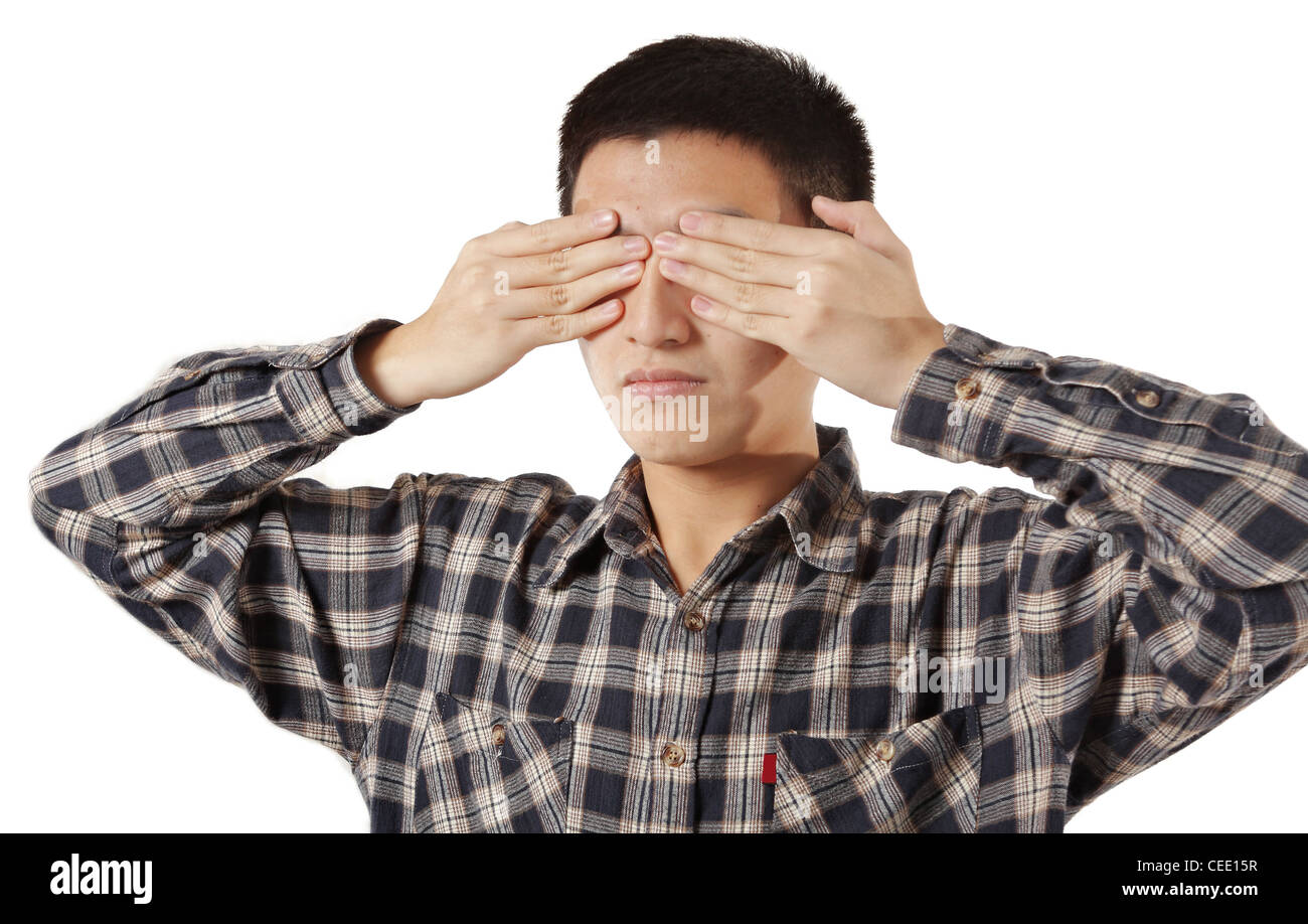 Portrait of a young man covering his eyes with hands Stock Photo Alamy