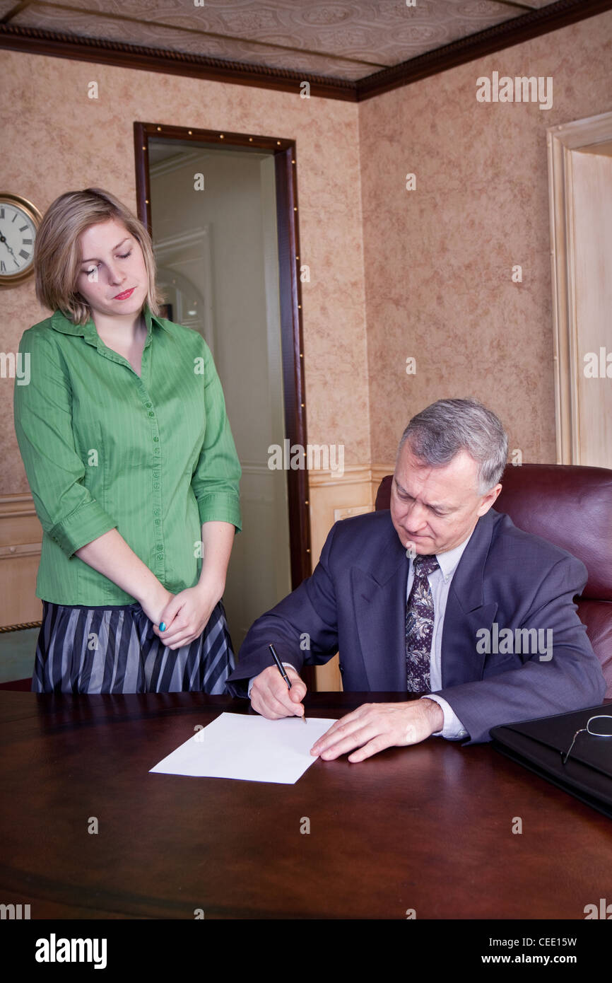 Office discussion between manager and admin Stock Photo