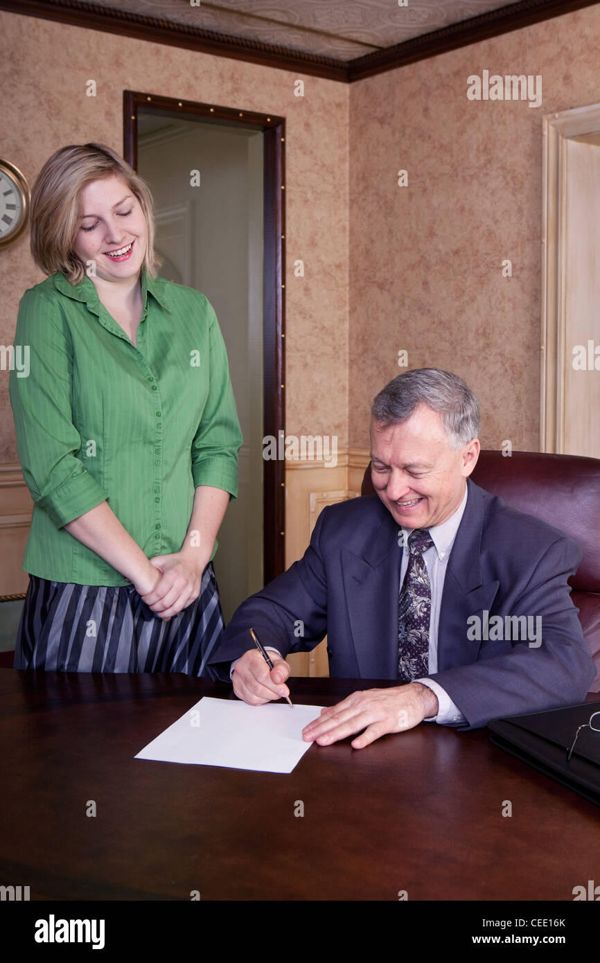 Office discussion between manager and admin Stock Photo