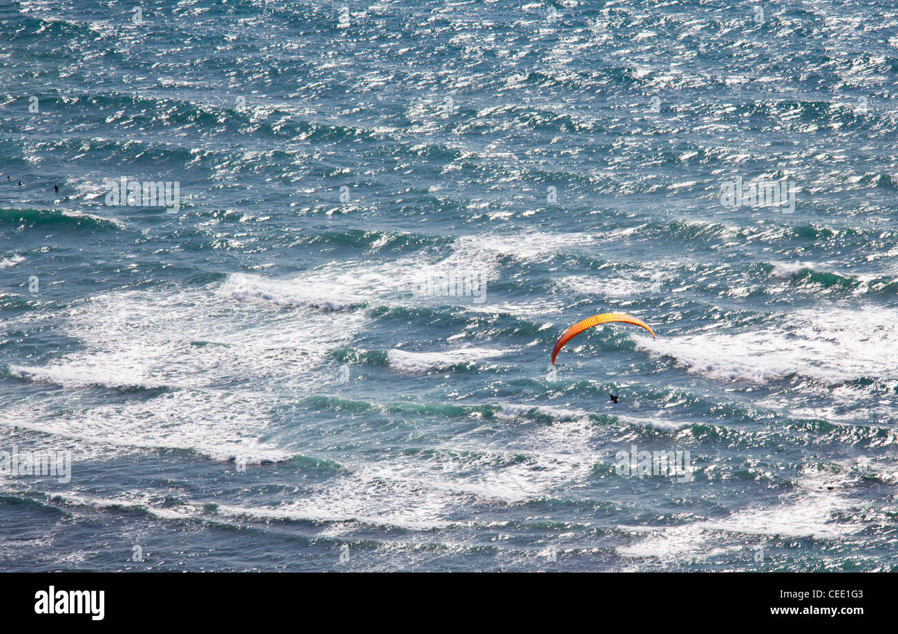 Overhead view of hang glider over rough ocean off Hawaii Stock Photo