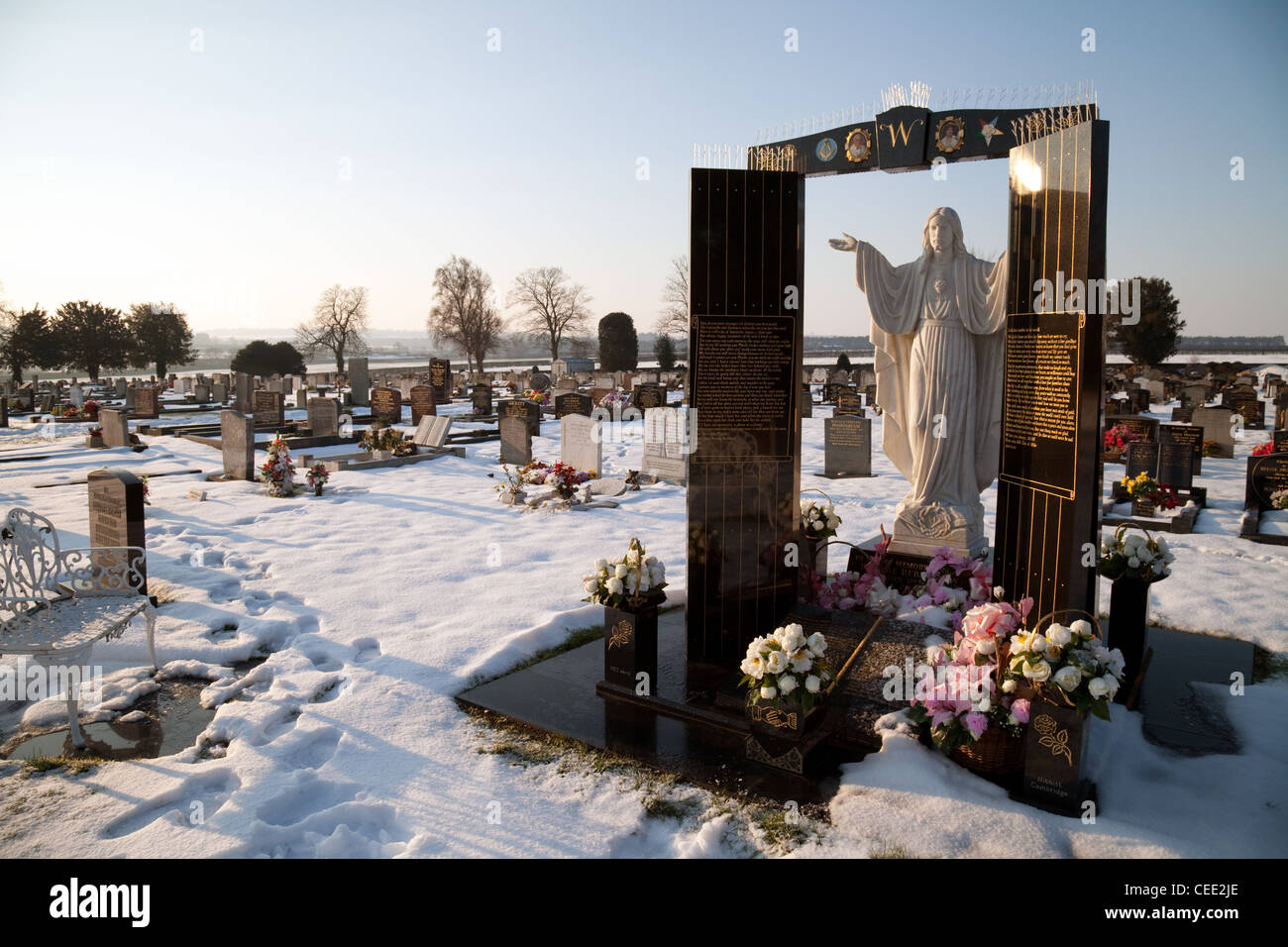 A grave and statues in winter, UK Stock Photo Alamy