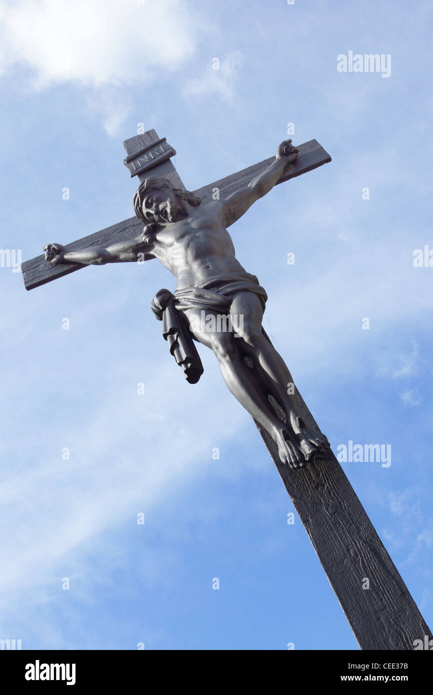 Jesus on the cross against a blue sky Stock Photo - Alamy