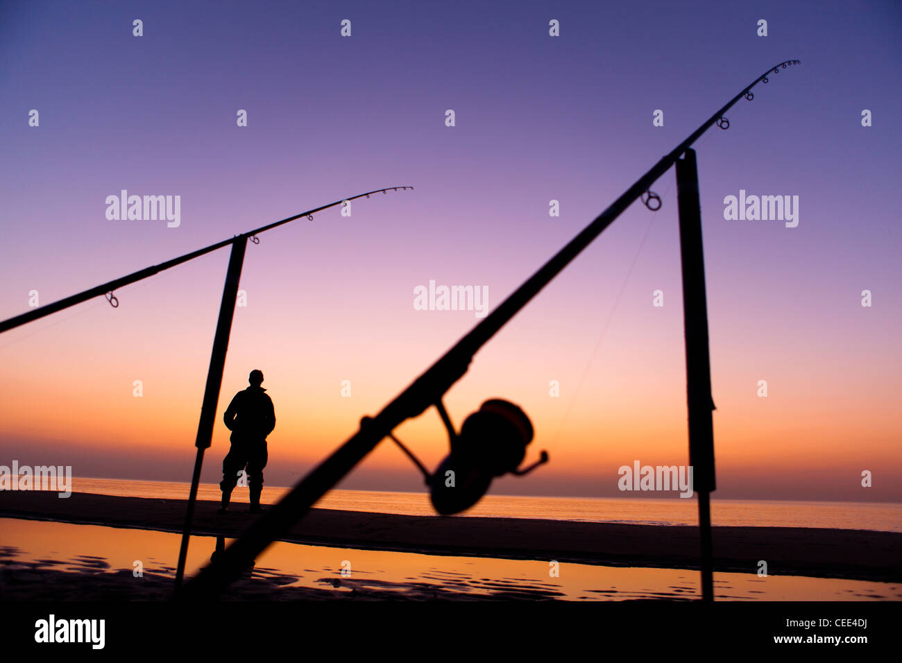 Fisherman beach fishing-rod sunset Noordwijk Holland Europe Stock Photo