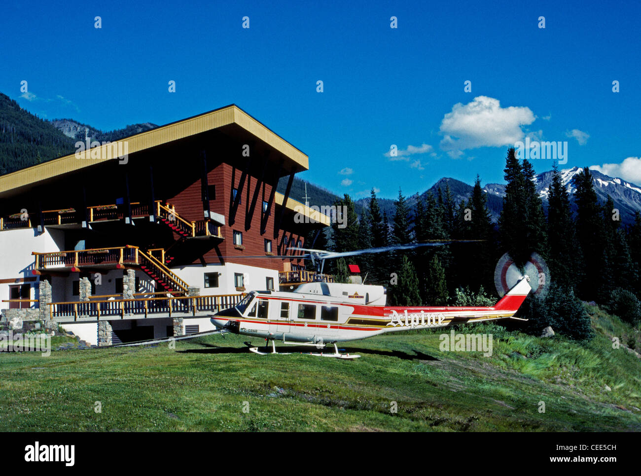 Helicopters arrive in summer to take guests at the alpine Bugaboo Lodge into the Purcell Mountains for heli-hiking in British Columbia (BC), Canada. Stock Photo