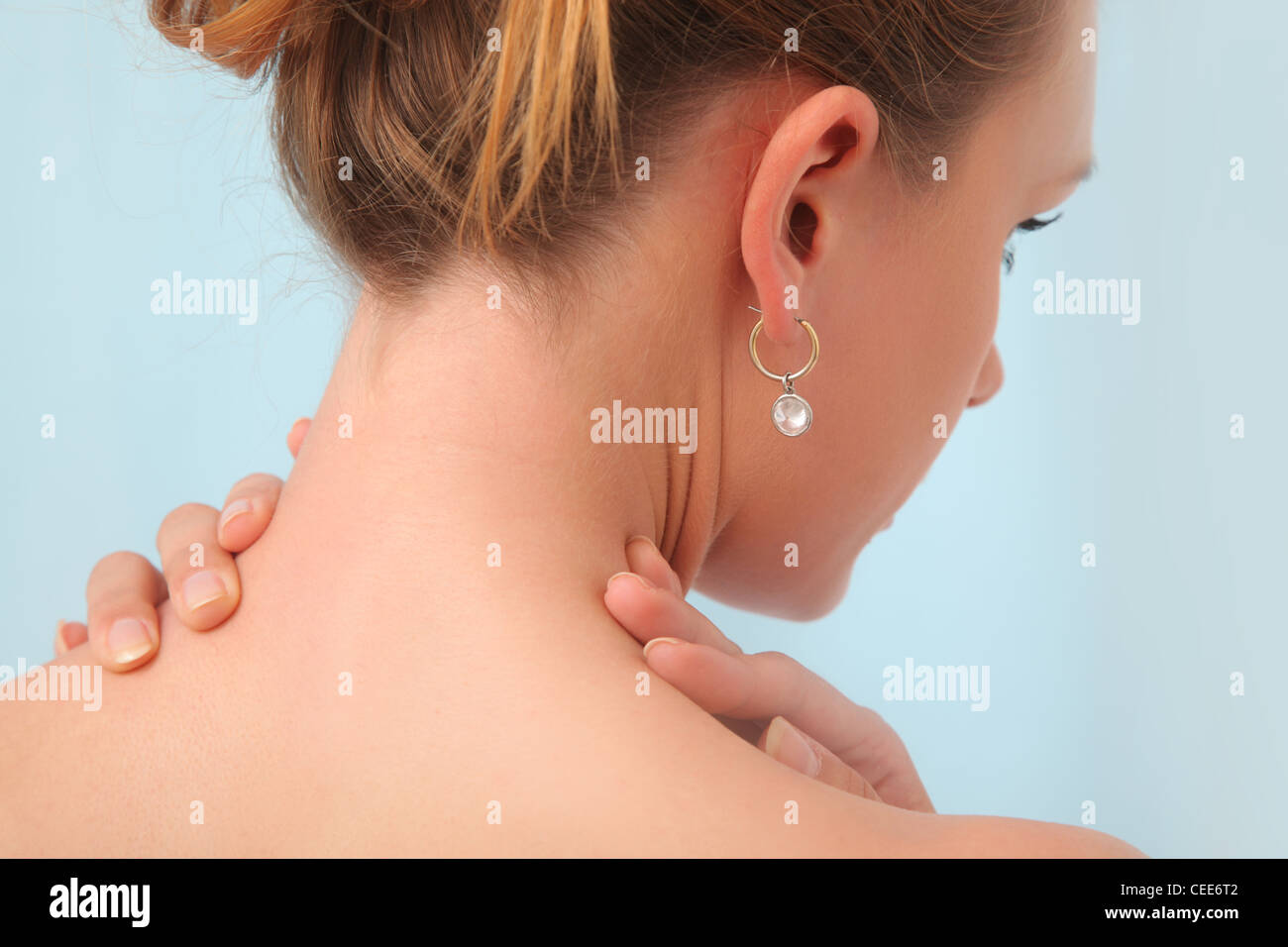 Young woman has pain in neck. Stock Photo