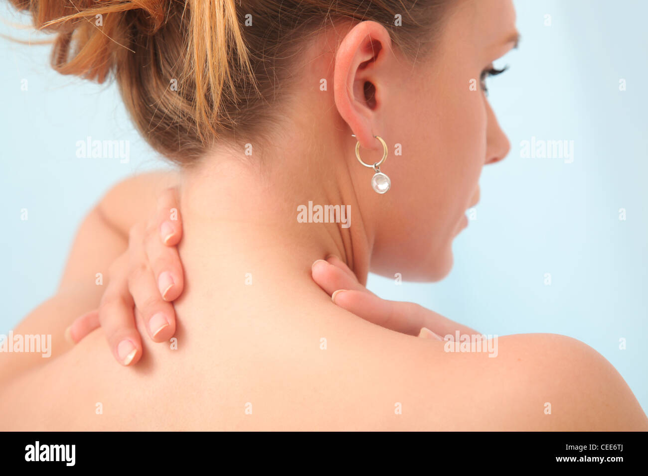Young woman has pain in neck. Stock Photo