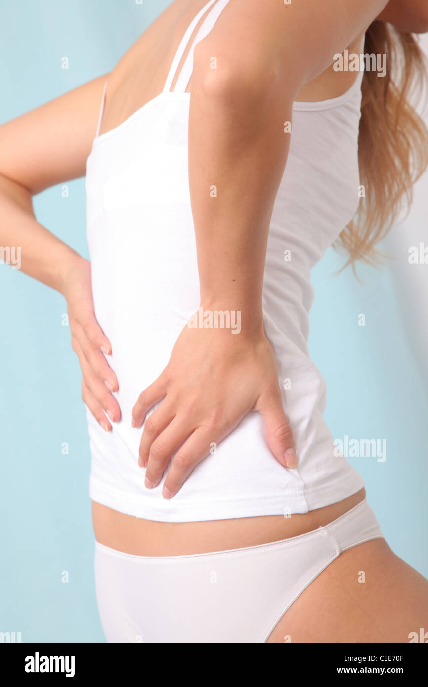Young woman has pain in back. Stock Photo