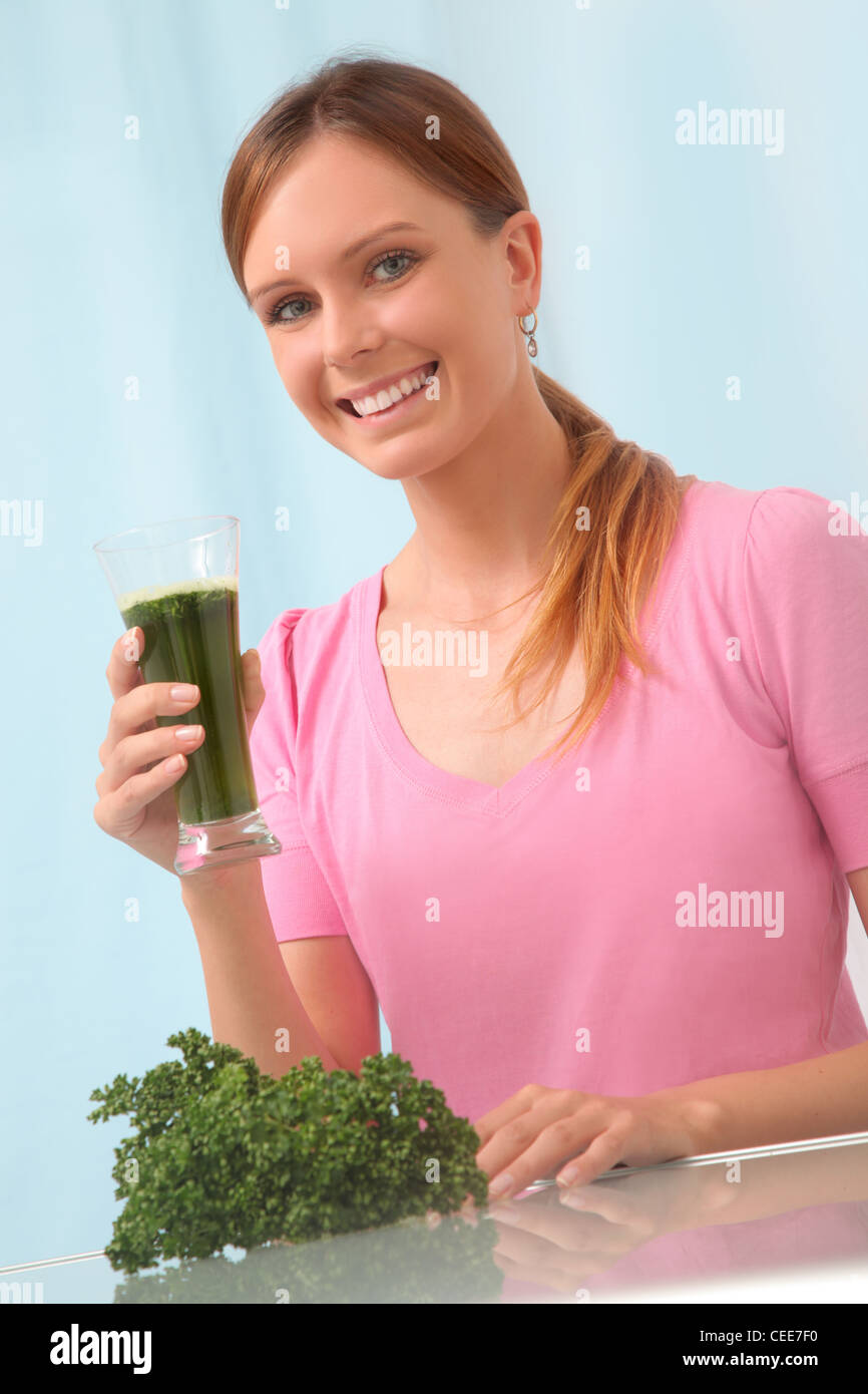 Young woman drinking parsley juice to detox. Stock Photo