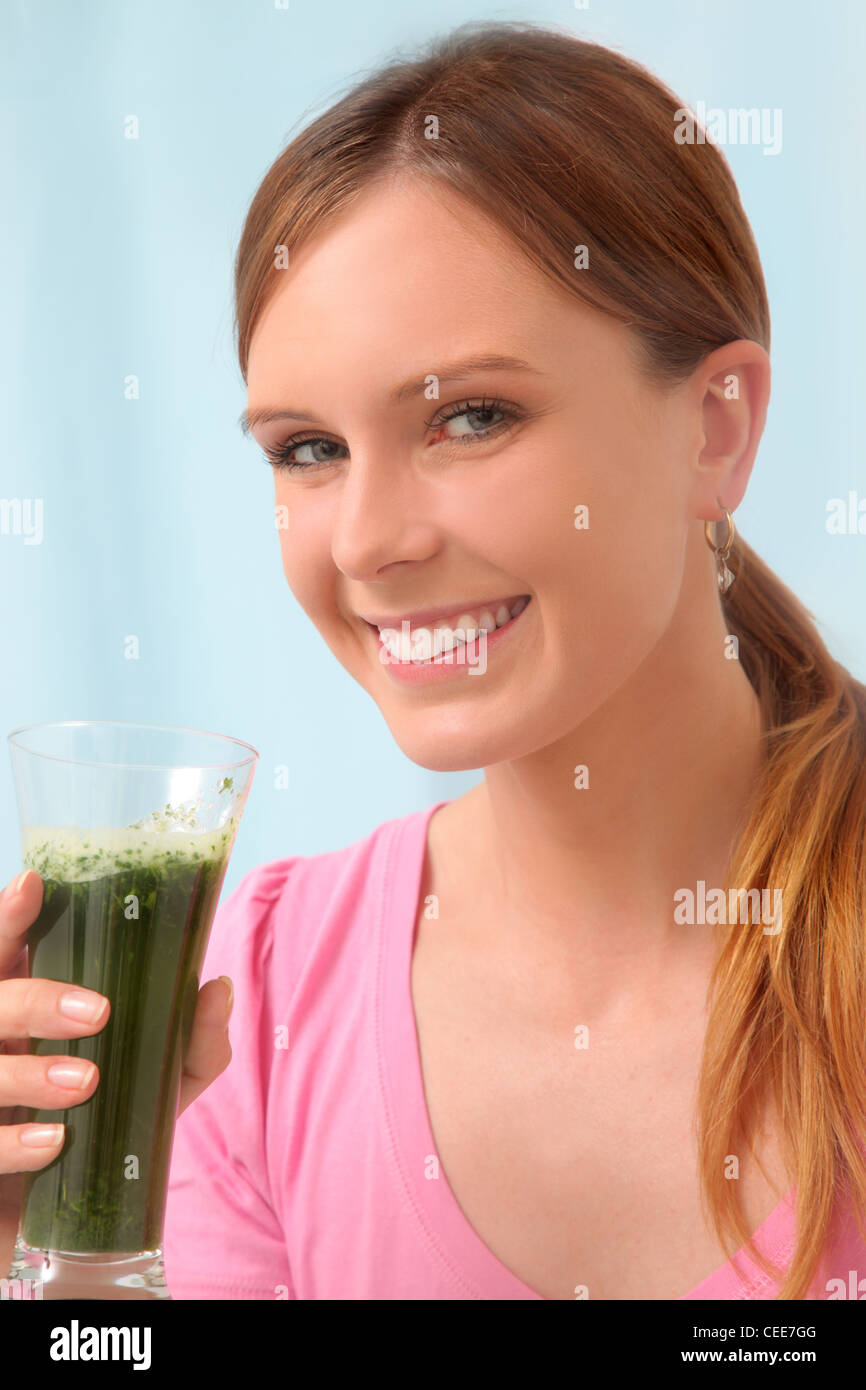 Young woman drinking parsley juice to detox. Stock Photo