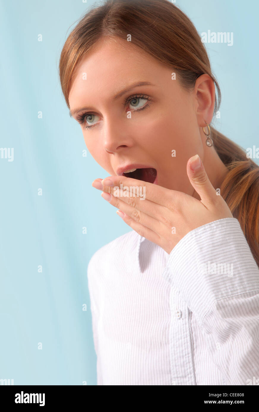 Young woman yawns. Stock Photo