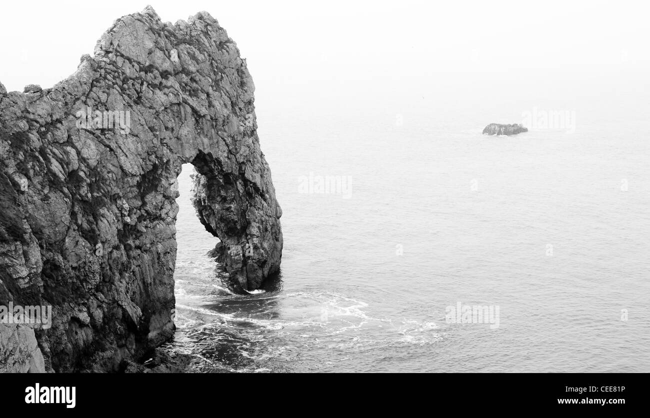 Black and White Durdle Door Coastal Rock Arch in Calm Lulworth Cove on the British Coast Stock Photo