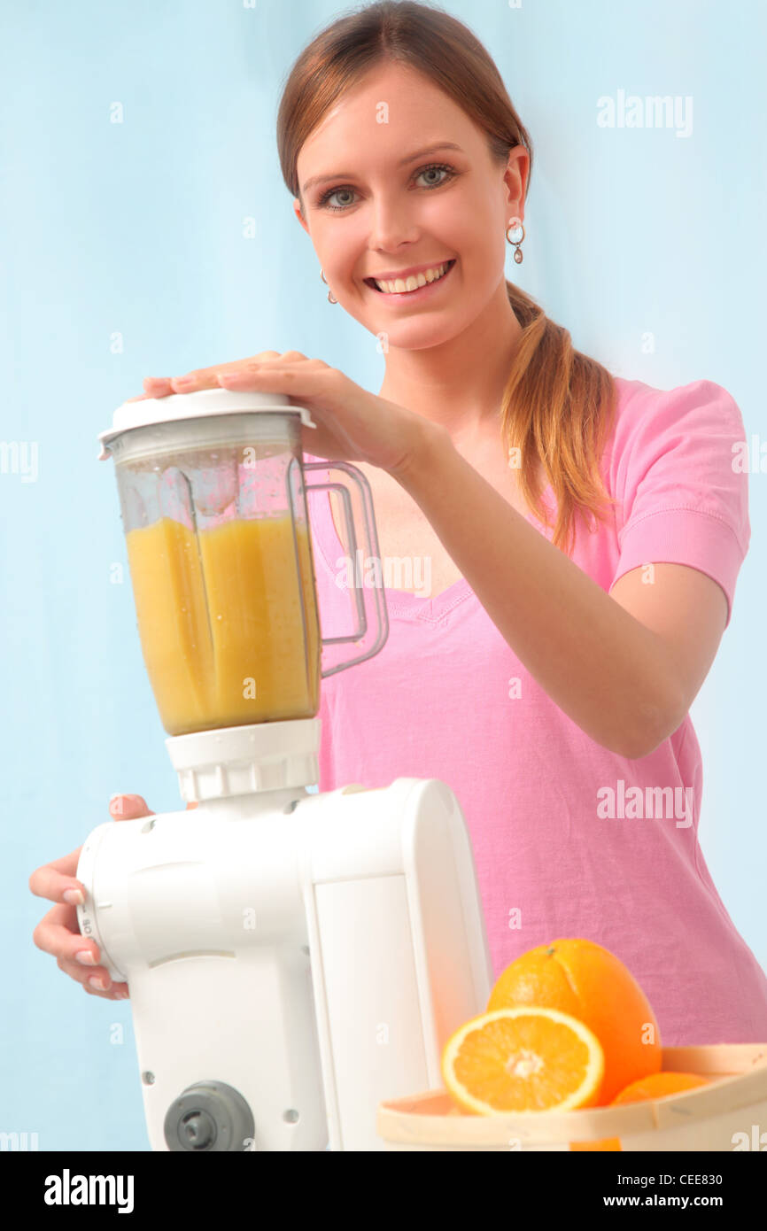 Young woman preparing juice. Stock Photo