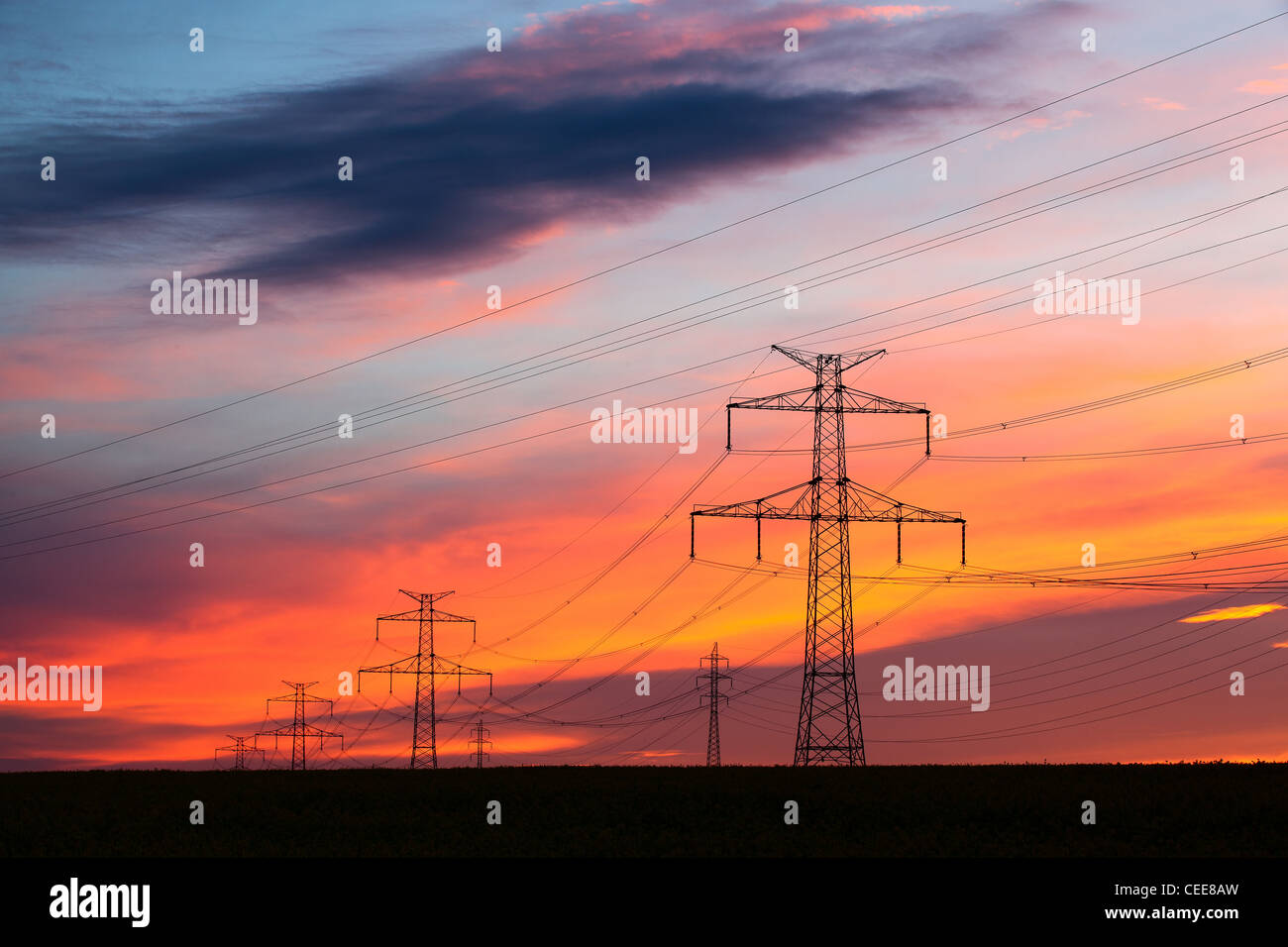 Transmission towers on the hills at red sunset Stock Photo - Alamy