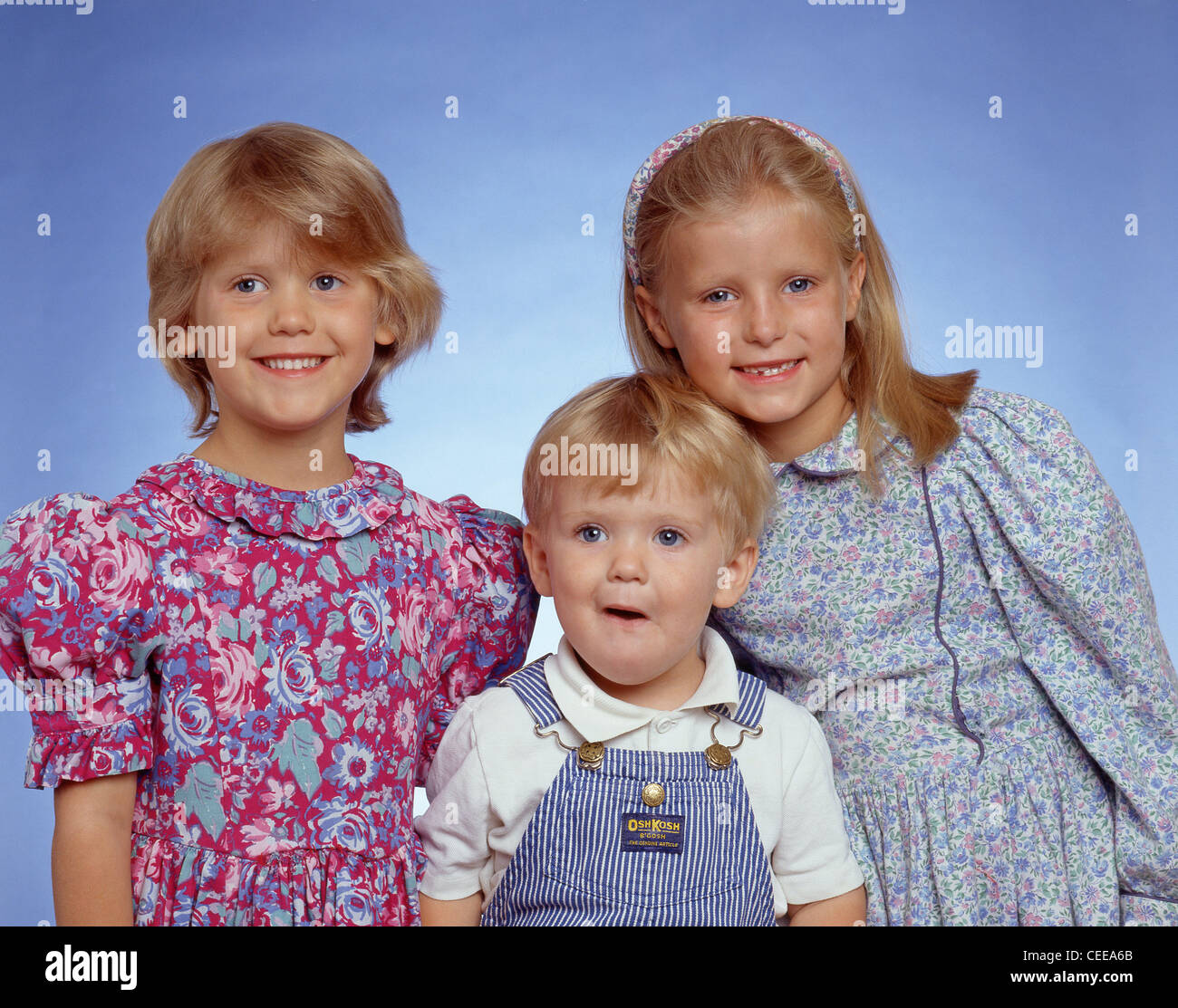 Brother and sisters in studio, Berkshire, England, United Kingdom Stock