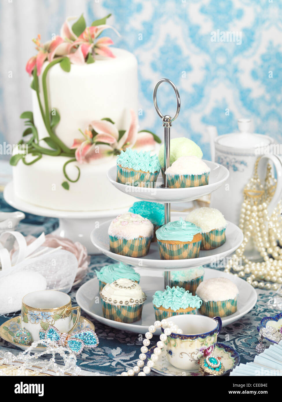 Still life photo of a luxurious tea party with sweets, jewellery and accessories Stock Photo