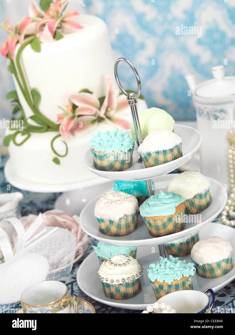 Food still life photo of cupcakes, china and a cake on a table Stock Photo