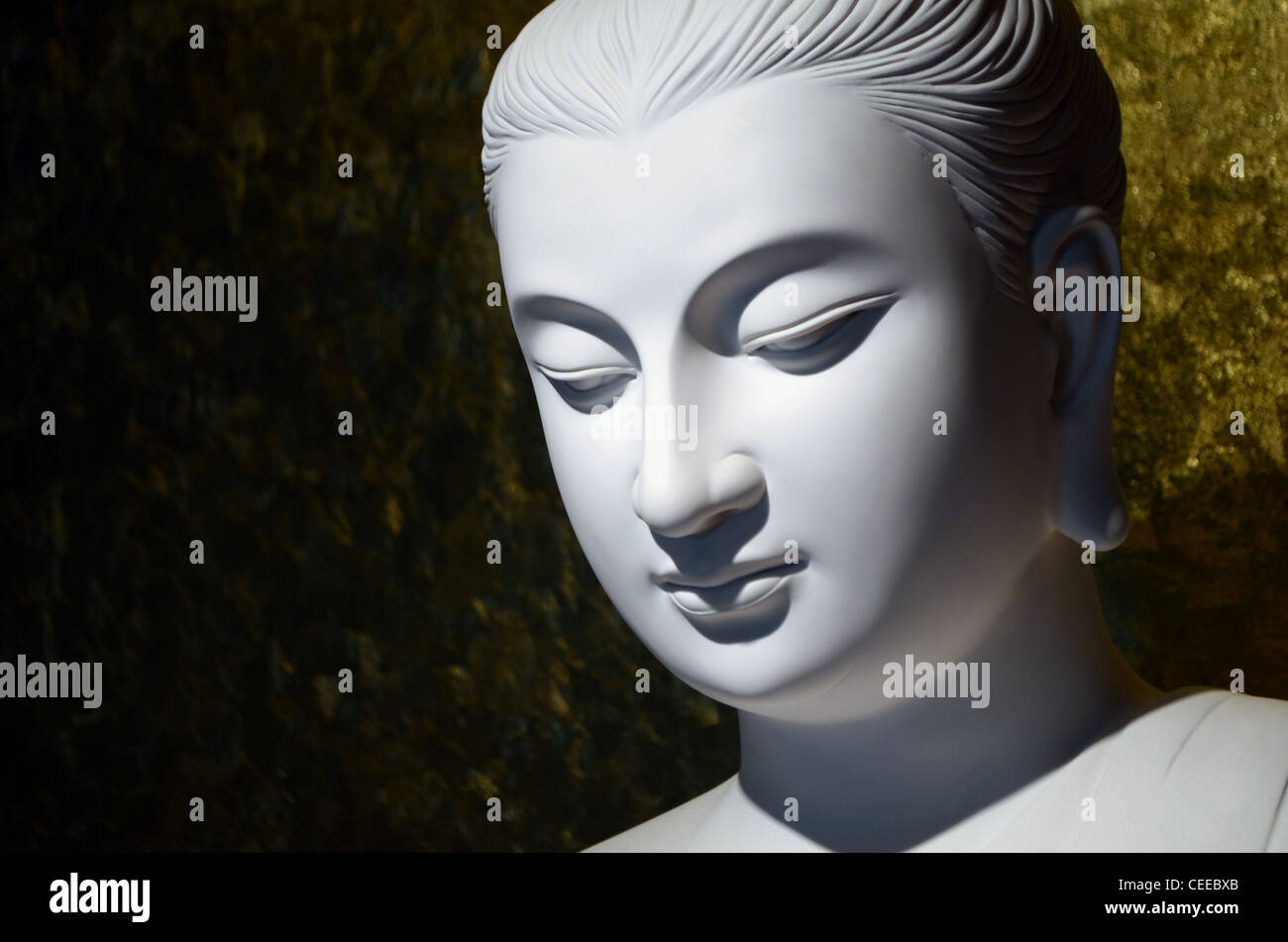 Closeup of white Buddha statue in meditation Stock Photo