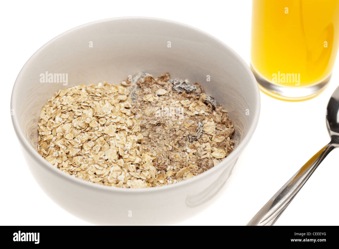 Plain white cereal bowl half filled each with Museli and rolled oats Stock Photo
