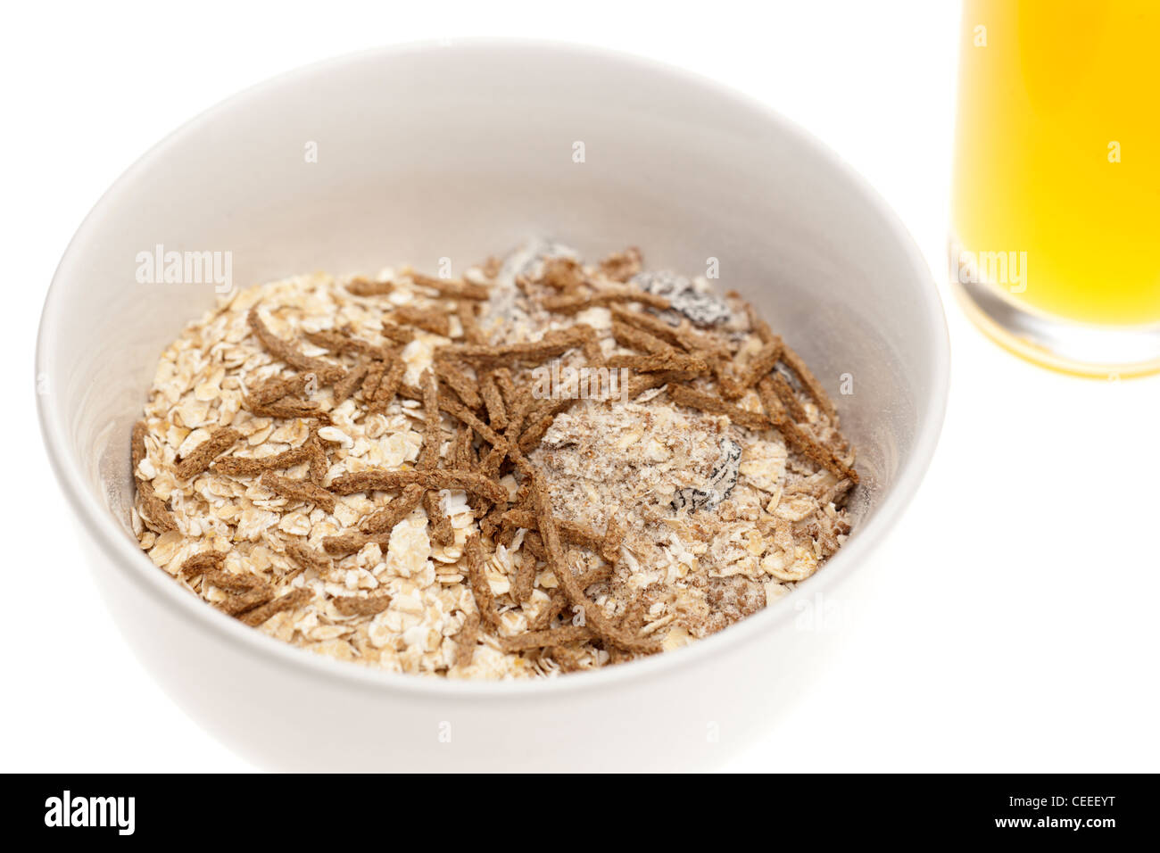 Plain white cereal bowl filled with Muesli and rolled oats with a sprinkling of bran flakes Stock Photo