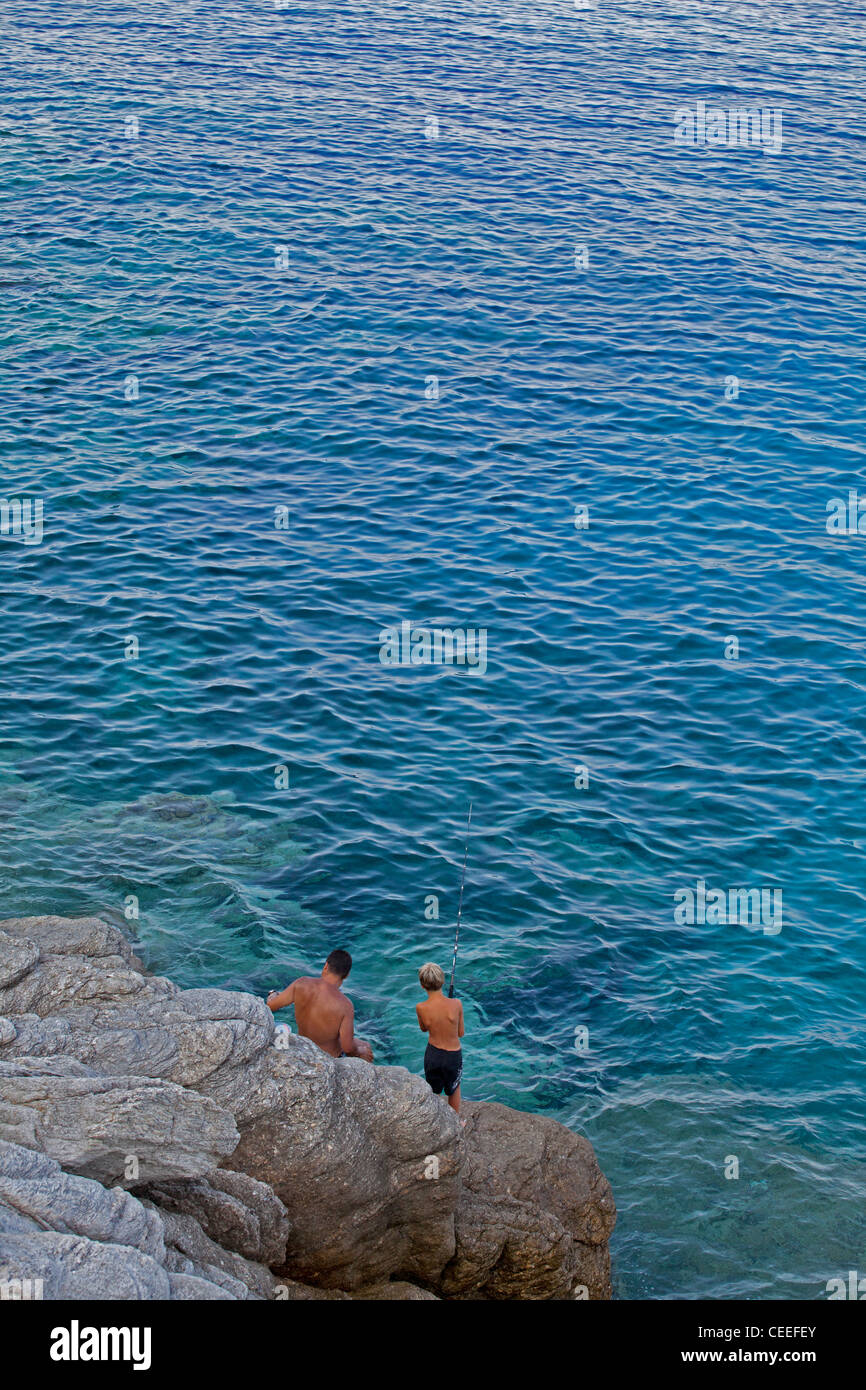 Father and son fishing,Armenistis beach,Sithonia,Chalkidiki,Aegean sea Stock Photo