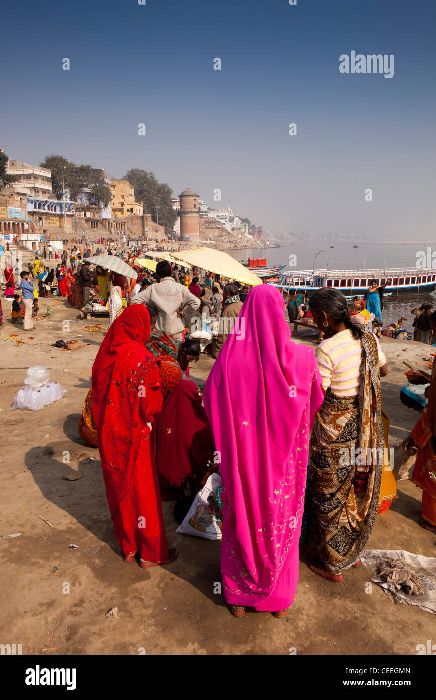 India, Uttar Pradesh, Varanasi, Assi Ghat, brightly dressed pilgrims gathered on banks of River Ganges Stock Photo