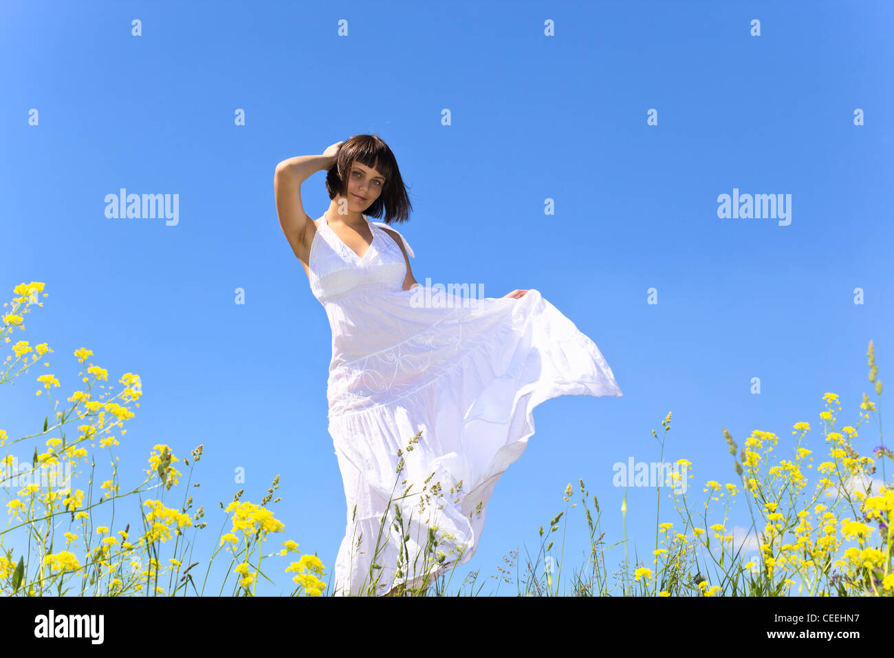 Young girl on a meadow in white dress Stock Photo - Alamy