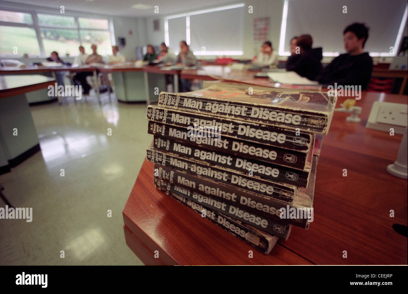 A pile of 'Man Against Disease' science text books in a classroom Stock Photo