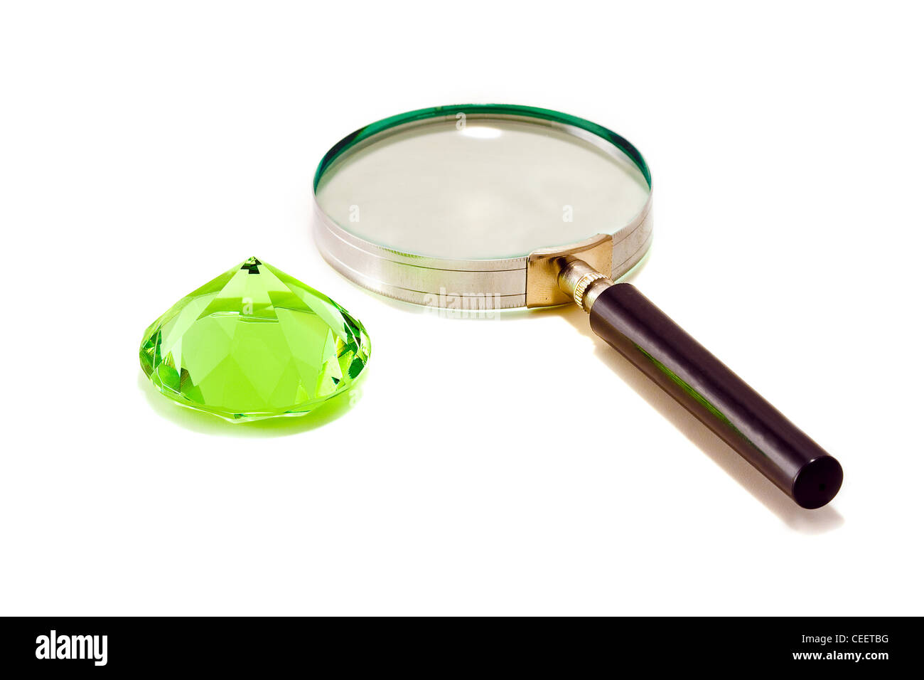 Green diamond crystall with magnifier Stock Photo