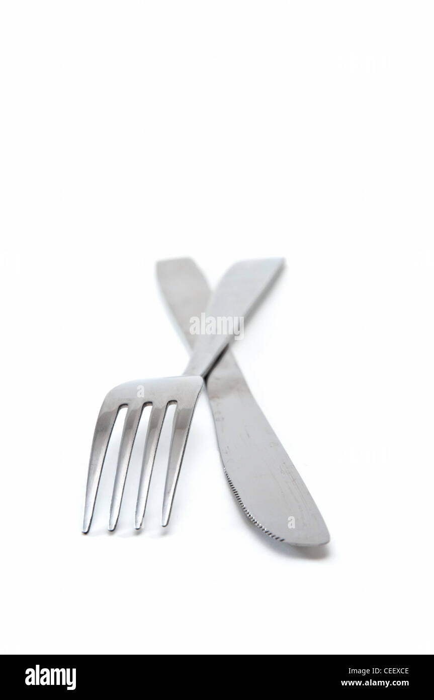 Fork and a knife over a white background Stock Photo Alamy