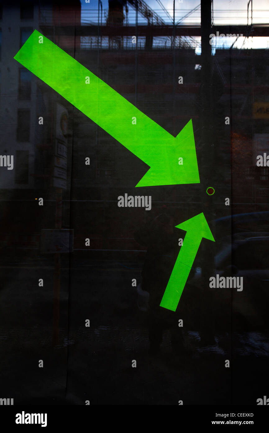 Arrows pointing to hole in shop window in the Kreuzberg district of Berlin. Stock Photo